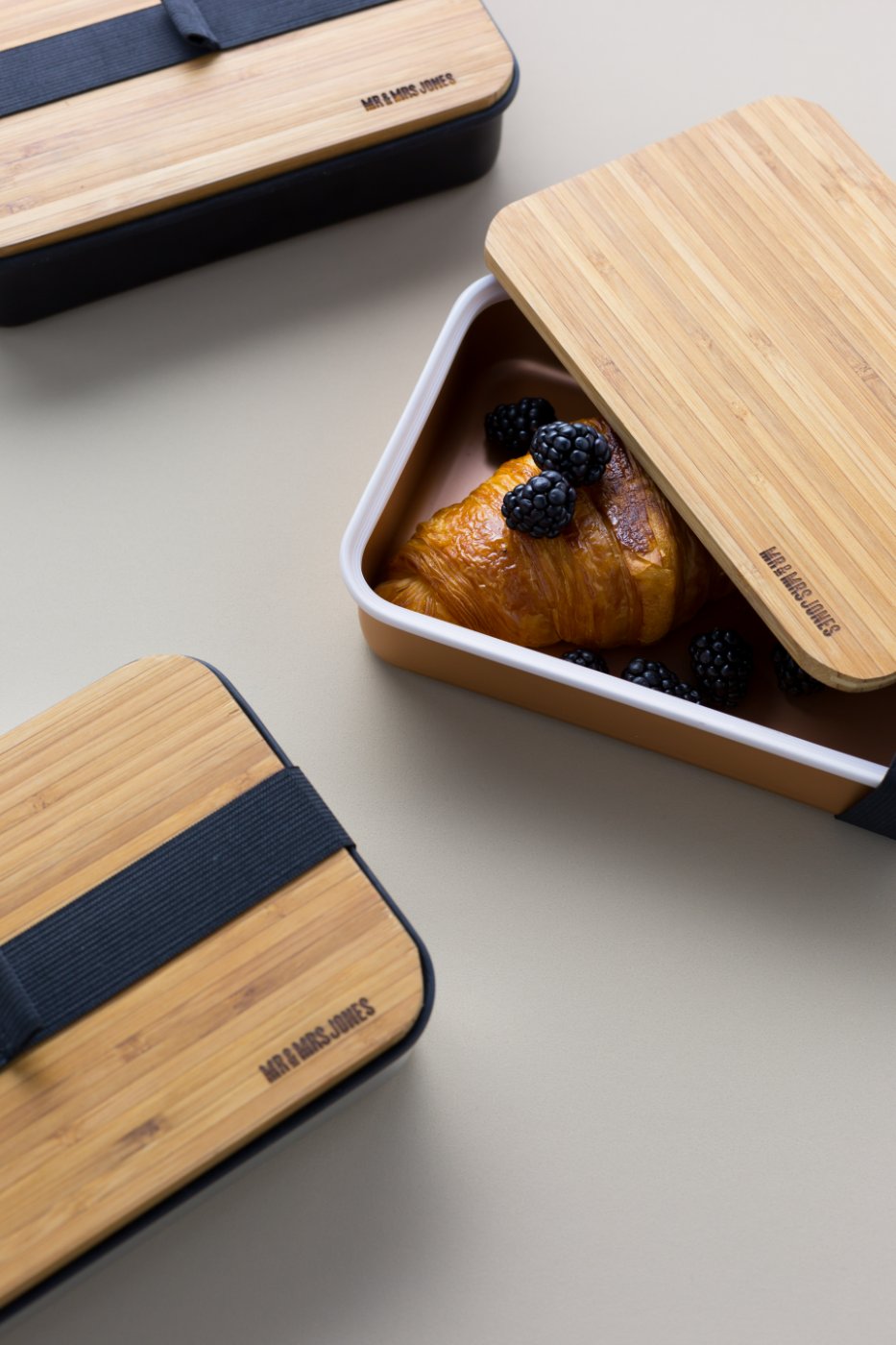 Bamboo bento box with croissant and blackberries
