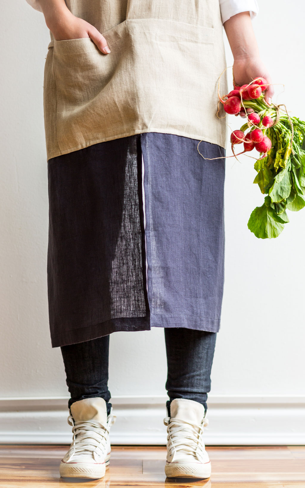 Linen apron holding radishes